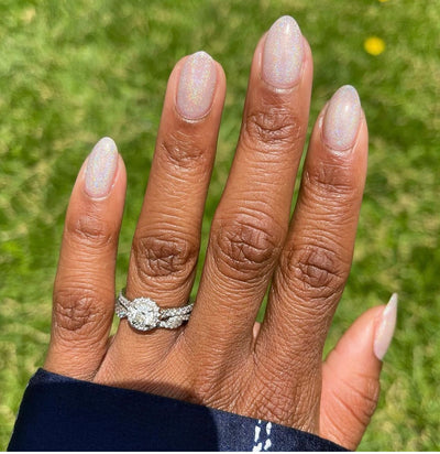 nails painted with a holographic topper