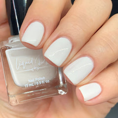 Picture of fingernails painted with a milky white non toxic vegan nail polish