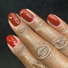 Picture of fingernails painted with a deep maroon vegan non- toxic nail polish