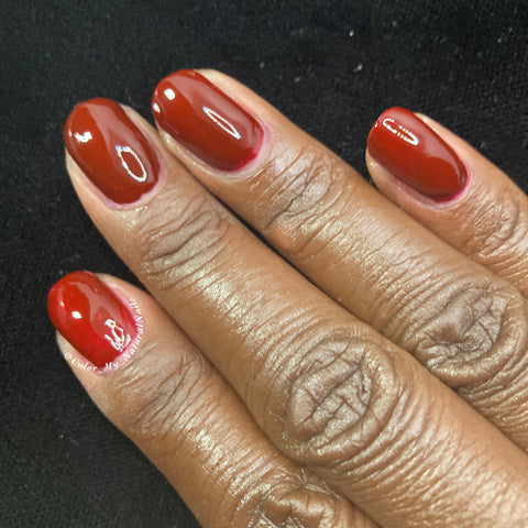 Image of Picture of fingernails painted with a deep maroon vegan non- toxic nail polish